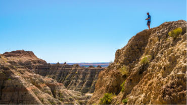 man standing on top of bluff